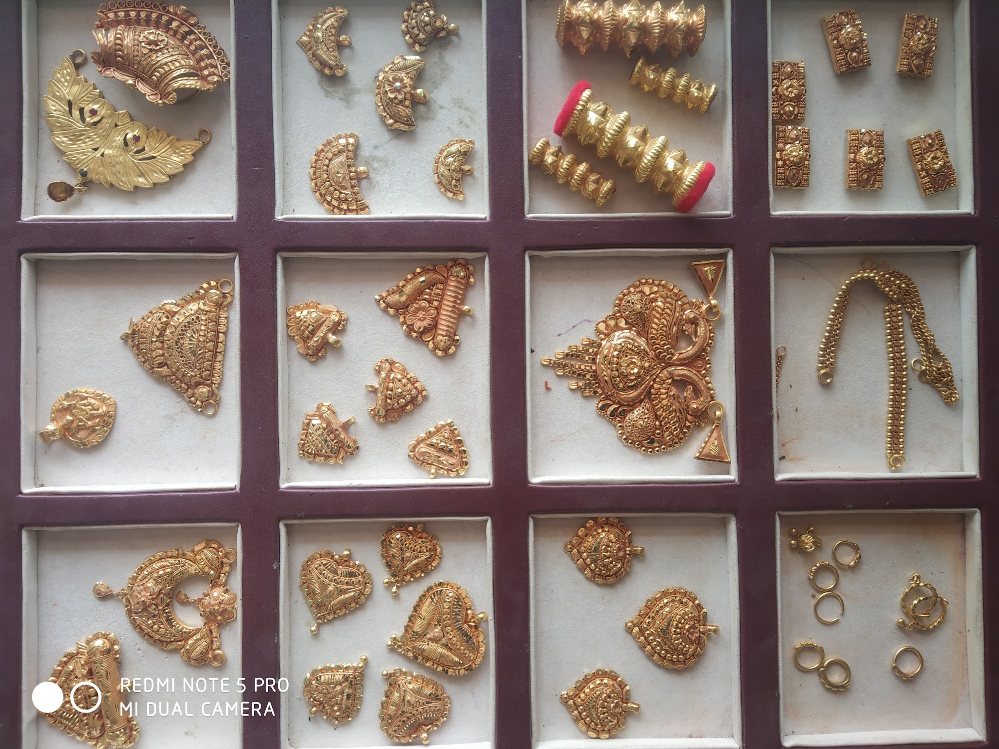 Compartment tray showcasing handcrafted gold jewellery ornaments